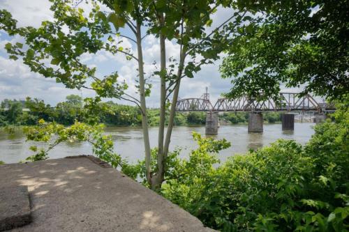 a bridge over a river with a bridge in the background at Stunning Riverfront Getaway in Downtown Nashville in Nashville