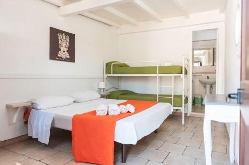 una camera con un letto con un tavolo e letti a castello di Villa con Piscina 150mt dal Mare 8 Posti OA ad Alcamo