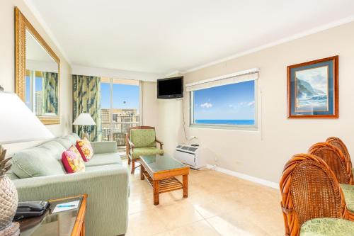a living room with a couch and a table at Luana Waikiki Hotel & Suites in Honolulu
