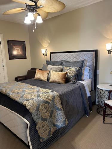 a bedroom with a large bed and a ceiling fan at Norfolk Guest House Inn in Guelph