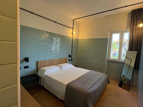 a bedroom with a bed and a window at Re Versiliana Hotel in Marina di Pietrasanta