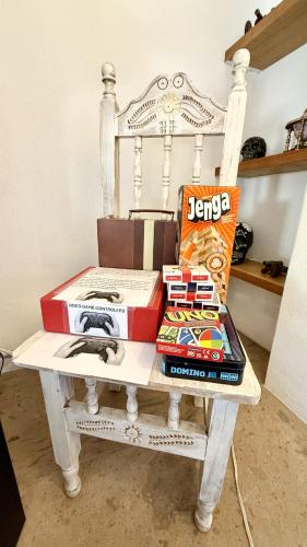 a table with boxes on top of a white chair at San Angel Villas in San Antonio