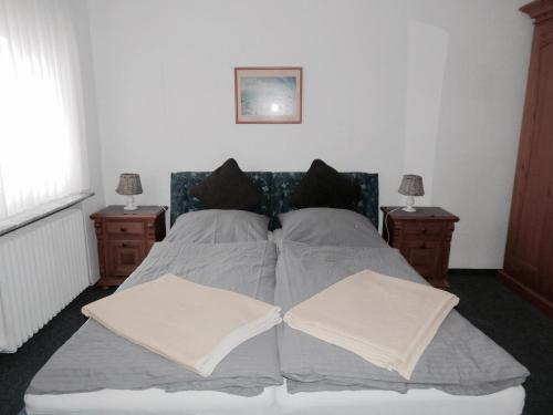 a bedroom with a bed with two pillows at Haus Hilde in Norderney