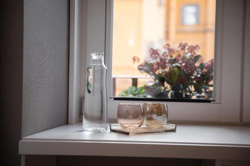 a bottle and two glasses sitting on a window sill at Nineteen House in Frascati