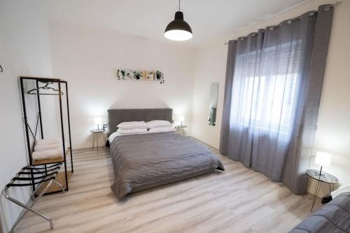 a bedroom with a bed and a large window at Luz de Salento B&B in Lecce