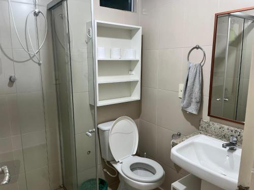 a bathroom with a toilet and a sink and a shower at Flat 204 beira mar in Cabedelo