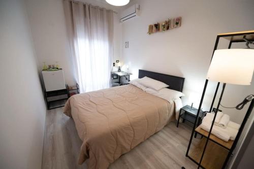 a bedroom with a bed and a lamp at Luz de Salento B&B in Lecce