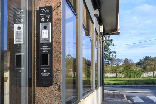 a parking meter on the side of a building at Hotel Alda Narón in Narón