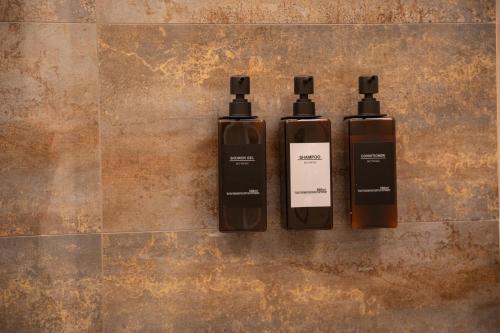 two bottles ofodorizers sitting on a tile floor at Nineteen House in Frascati