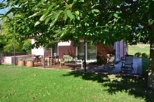 a house with a porch with chairs and a table at Wine Tourism - Quinta do Ameal in Refoios do Lima