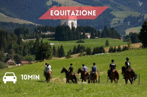 a group of people riding horses in a field at Fuori da ZTL - Asiago a due passi da tutto in Asiago