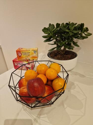 a basket of fruit on a table with a plant at Zu Gast im Goldparadies, Ferienwohnung in Sulzbach-Rosenberg