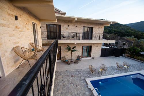 a house with a balcony with a swimming pool at Stone Villa with pool Montenegro Star in Kaluđerac