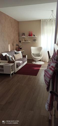 a living room with a bed and a couch and a chair at La casa di Lucia in Bergamo