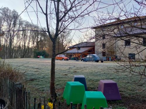 a group of chairs sitting in a field next to a building at Gîte du Longevent in Meximieux