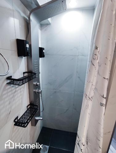 a shower stall with a shower curtain in a bathroom at Modern studio in the city center in Chalkida