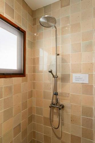 a shower with a shower head in a bathroom at Art Luxe Homes Chiang Mai in Doi Saket