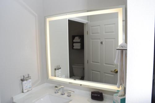 a bathroom with a large mirror over a sink at Staybridge Suites Tucson Airport by IHG in Tucson