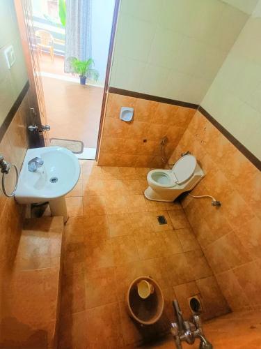 a bathroom with a toilet and a sink at Calangute in Guest House in Calangute