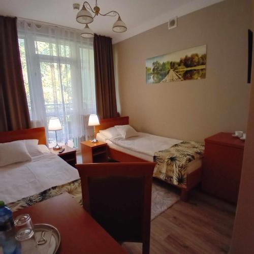Una cama o camas en una habitación de Hotel Olimp
