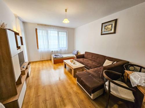 a living room with a couch and a table at Mountain Dream A8 apartment in Borovets