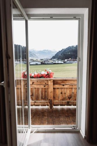 a large window with a view of a field at Lebe`schlitters - Das Ferienapartmenthaus im Zillertal in Schlitters