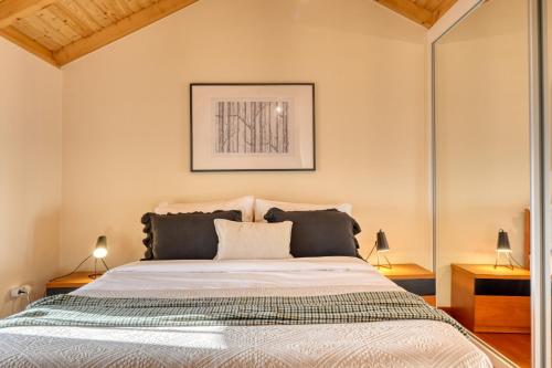 a bedroom with a large bed with two lamps at Ocean View Cottage a Home in Madeira in Fajã da Ovelha