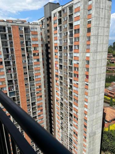 a view of two tall buildings from a balcony at Private Room Sabaneta in Sabaneta