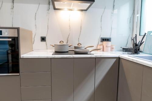 a kitchen with two pots and pans on a counter at Oikos Charming Island Retreat in Platánion