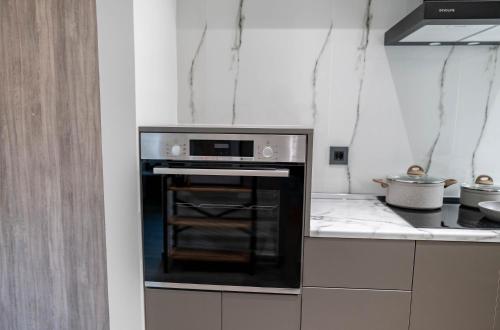 a kitchen with a black oven in a kitchen at Oikos Charming Island Retreat in Platánion