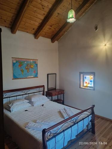 a bedroom with a large bed with a wooden ceiling at George Traditional Villa in Marouloú