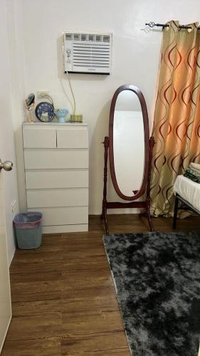 a dressing room with a mirror and a dresser at Lubrin Townhouse in San Pablo