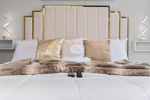 a bed with a blanket and pillows on it at NEW! Luxury Champagne Towers Kingbed FreeParking in Atlanta