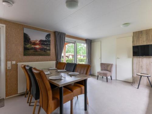 a dining room with a table and chairs at Woodchalet in Vessem