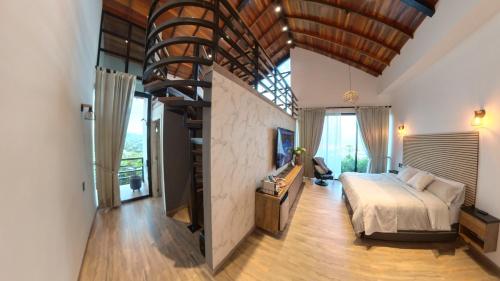 a bedroom with a bed and a staircase in a room at Casa en el Cielo in Cali