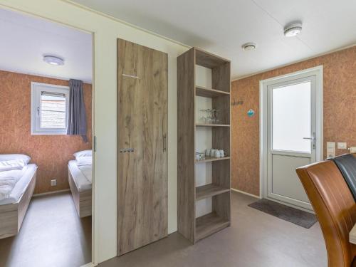 a bedroom with a sliding door and a bed at Woodchalet in Vessem