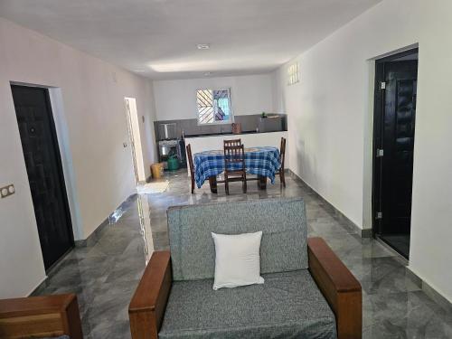 a living room with a couch and a table at Maison d ampasikely in Nosy Be