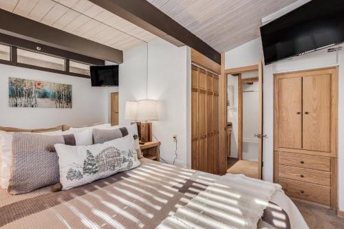 a bedroom with a large bed and a tv on the wall at Laurelwood Condominiums 414 in Snowmass Village