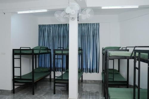 a room with four bunk beds in a room at Hotel Aamis Villa in Pulpally
