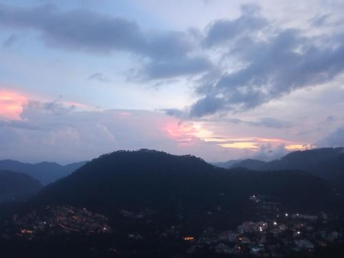 a view of a city from a mountain range at Kumaon Lake's Home stay in Nainital