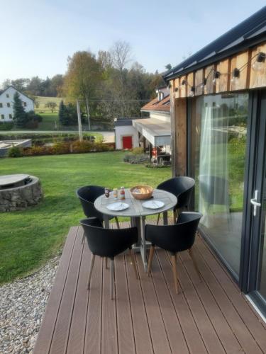 a patio with a table and chairs on a deck at Penzion Only in Kunějov