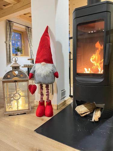 a gnome is standing next to a fireplace at Chata pod Mníchom in Terchová
