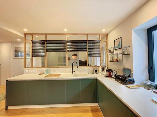 a kitchen with a sink and a counter top at Maison 4 Chambres Côte des Basques Avec Piscine in Biarritz