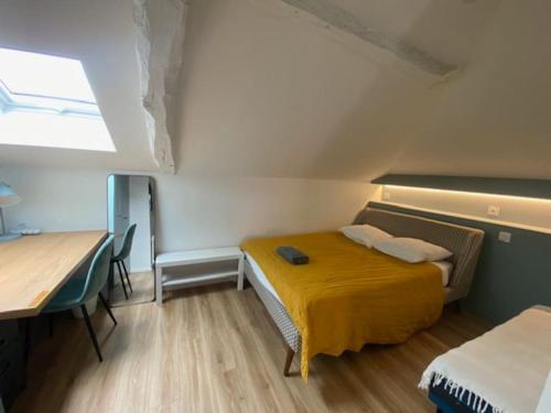 a room with a bed and a desk and a table at Maison 4 Chambres Côte des Basques Avec Piscine in Biarritz