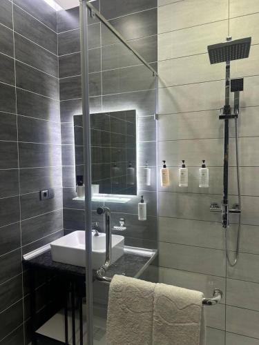 a bathroom with a sink and a shower at Home Boutique Hotel in Tashkent