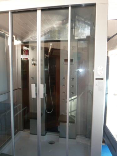 a glass shower in a bathroom with a shower at Le Ch'tipanier in Morcenx