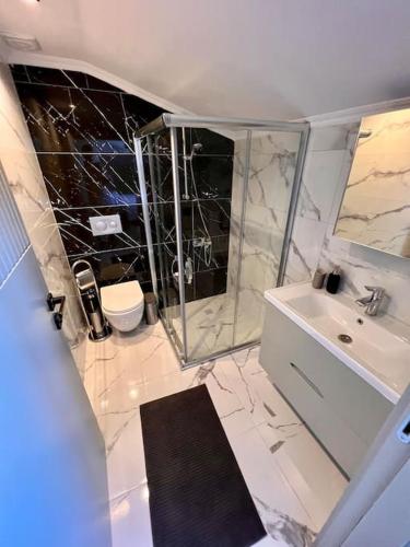 a bathroom with a shower and a sink and a toilet at Kemer Green Park Villa in Kemer