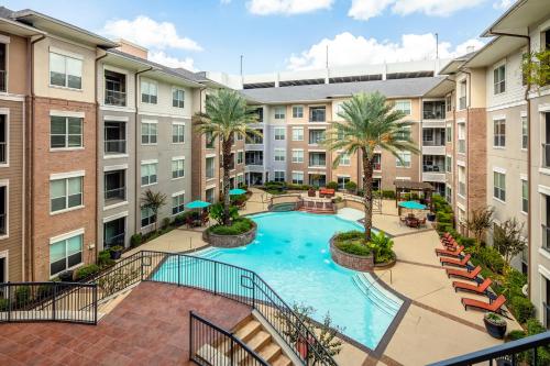 an overhead view of a pool in an apartment complex at Gorgeous Furnished Apartments near Texas Medical Center & NRG Stadium in Houston