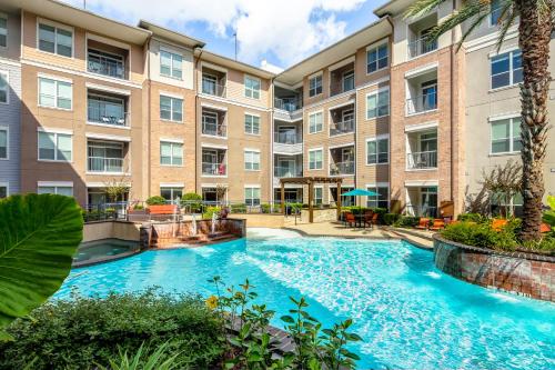 an image of a swimming pool at a apartment complex at Gorgeous Furnished Apartments near Texas Medical Center & NRG Stadium in Houston
