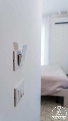a door to a bedroom with a bed at Agathè Luxury Bed and Breakfast in Marina di Schiavonea